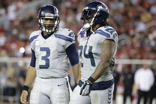 Seattle Seahawks quarterback Russell Wilson (3) and running back Marshawn Lynch (24) during the second half of an NFL football game against the San Francisco 49ers in Santa Clara, Calif., Thursday, Oct. 22, 2015. (AP Photo/Marcio Jose Sanchez)