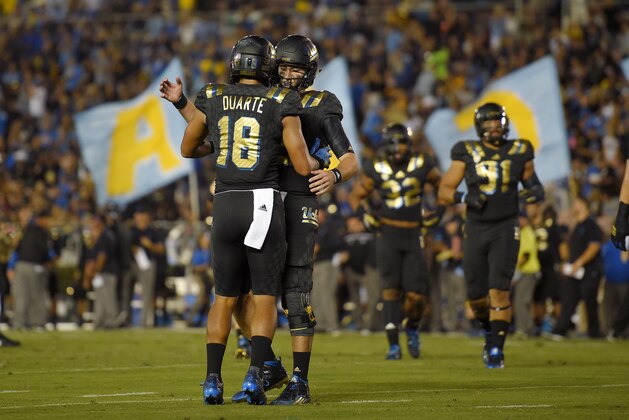 UCLA wide receiver Thomas Duarte, left, is congratulated by quarterback Josh Rosen after making a touchdown catch during the first half of an NCAA college football game against California, Thursday, Oct. 22, 2015, in Pasadena, Calif. (AP Photo/Mark J. Terrill)