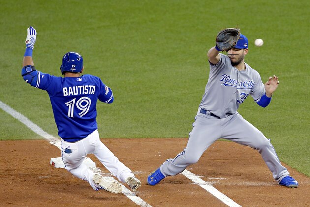 Toronto Blue Jays' Jose Bautista is safe at first past Kansas City Royals first baseman Eric Hosmer during the fourth inning in Game 5 of baseball's American League Championship Series on Wednesday, Oct. 21, 2015, in Toronto. (AP Photo/Paul Sancya)