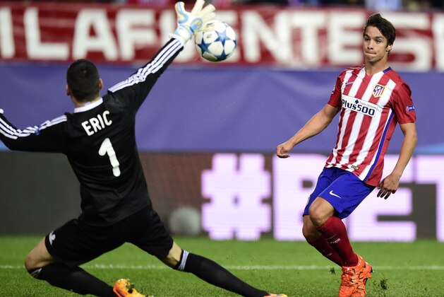 Atletico Madrid's midfielder Oliver Torres (L) shoots to score in front of Astana's Serbian goalkeeper Nenad Erich during the UEFA Champions League group C football match Club Atletico de Madrid vs FC Astana at the Vicente Calderon stadium in Madrid on October 21, 2015.   AFP PHOTO/ JAVIER SORIANO        (Photo credit should read JAVIER SORIANO/AFP/Getty Images)