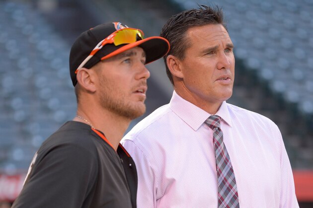ANAHEIM, CA - AUGUST 26: Jeff Mathis #6 of the Miami Marlins talks to assistant general manager Scott Servais of the Los Angeles Angels of Anaheim before the game on August 26, 2014 at Angel Stadium of Anaheim in Anaheim, California. (Photo by Matt Brown/Angels Baseball LP/Getty Images)