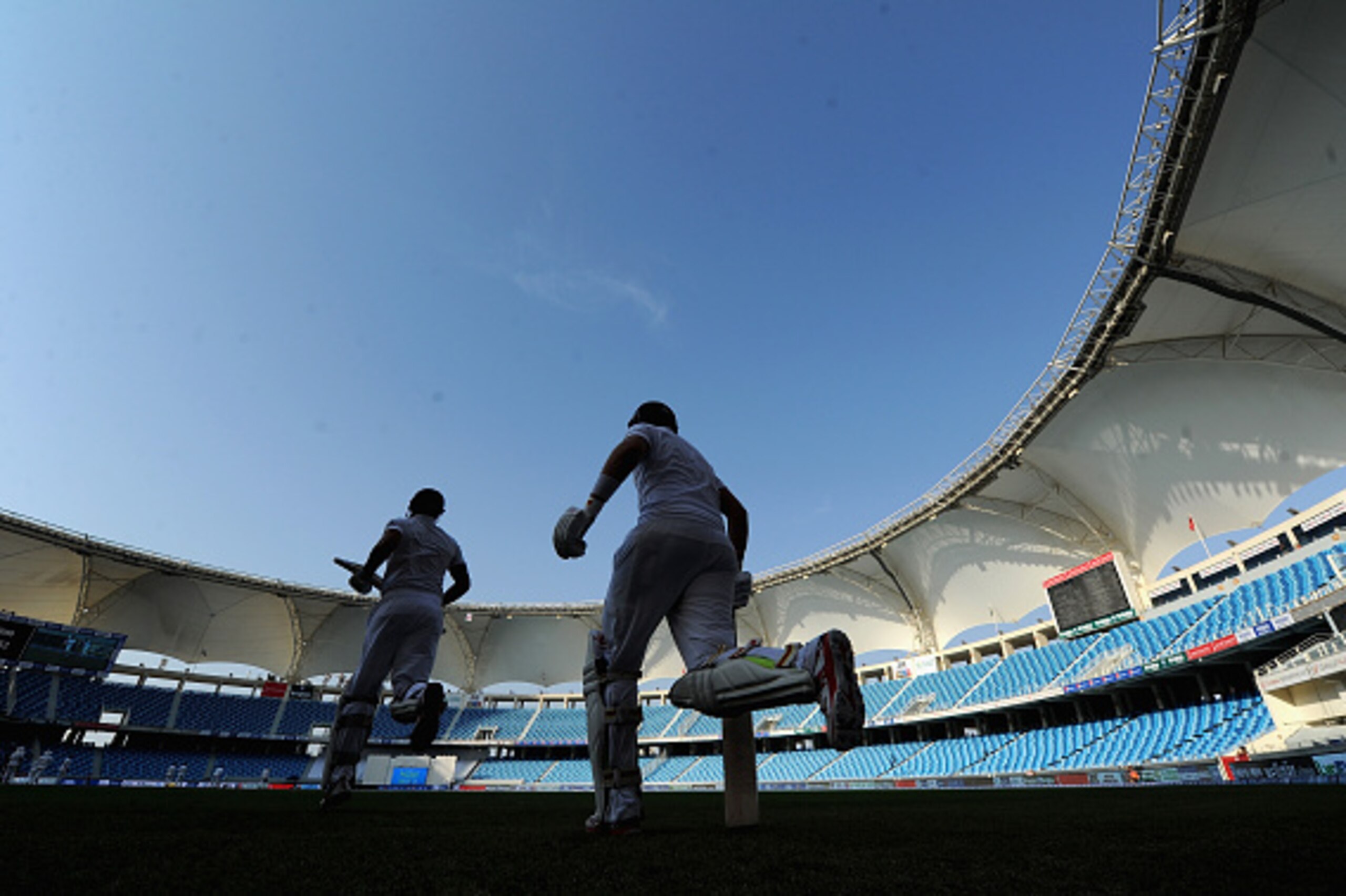 DUBAI, UNITED ARAB EMIRATES - OCTOBER 23:  England captain Alastair Cook and Joe Root run out to bat after tea during day two of the 2nd test match between Pakistan and England at Dubai Cricket Stadium on October 23, 2015 in Dubai, United Arab Emirates.  (Photo by Gareth Copley/Getty Images)