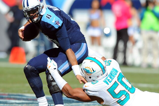 Oct 18, 2015; Nashville, TN, USA; Tennessee Titans quarterback Marcus Mariota (8) is sacked by Miami Dolphins defensive end Olivier Vernon (50) during the first half at Nissan Stadium. Mandatory Credit: Christopher Hanewinckel-USA TODAY Sports
