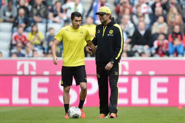 Dortmund's headcoach Juergen Klopp (R) and Dortmund's Turkish midfielder Nuri Sahin speak together ahead of the German first division Bundesliga football match FC Bayern Munich vs Borussia Dortmund in Munich, southern Germany on April 12, 2014. AFP PHOTO / CHRISTOF STACHE
DFL RULES TO LIMIT THE ONLINE USAGE DURING MATCH TIME TO 15 PICTURES PER MATCH. FOR FURTHER QUERIES PLEASE CONTACT DFL DIRECTLY AT + 49 69 650050.        (Photo credit should read CHRISTOF STACHE/AFP/Getty Images)