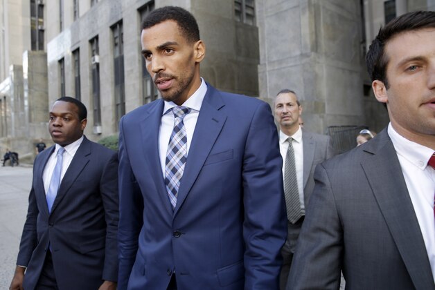 Thabo Sefolosha, second from left, leaves criminal court in New York, Wednesday, Oct. 7, 2015. The professional basketball player was about to give a handout to a man asking for money when police officers took him to the ground and arrested him, a former teammate testified Wednesday. (AP Photo/Seth Wenig)