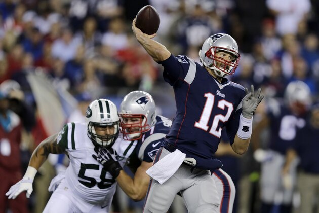 New England Patriots quarterback Tom Brady throws as New York Jets defensive end Jason Babin (58) pursues during the first half of an NFL football game Thursday, Oct. 16, 2014, in Foxborough, Mass. (AP Photo/Charles Krupa)
