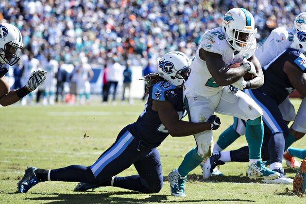 NASHVILLE, TN - OCTOBER 18:  Bobby McCain #28 of the Miami Dolphins runs the ball and is tackled by Michael Griffin #33 of the Tennessee Titans at LP Field on October 18, 2015 in Nashville, Tennessee.  The Dolphins defeated the Titans 38-10.  (Photo by Wesley Hitt/Getty Images)
