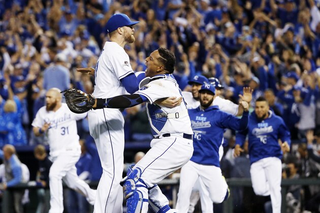 Kansas City Royals relief pitcher Wade Davis, left, and catcher Salvador Perez celebrates their 4-3 win against the Toronto Blue Jays in Game 6 of baseball's American League Championship Series on Friday, Oct. 23, 2015, in Kansas City, Mo. (AP Photo/Matt Slocum)