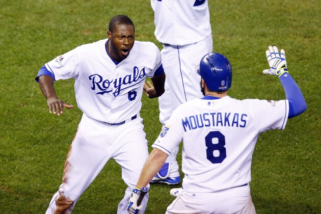 Kansas City Royals' Lorenzo Cain celebrates  after scoring on a hit by Eric Hosmer with Mike Moustakas against the Toronto Blue Jays during the eight inning in Game 6 of baseball's American League Championship Series on Friday, Oct. 23, 2015, in Kansas City, Mo. (AP Photo/Paul Sancya)