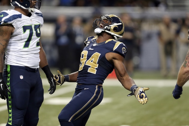 St. Louis Rams defensive end Robert Quinn celebrates after sacking Seattle Seahawks quarterback Russell Wilson during the third quarter of an NFL football game Sunday, Sept. 13, 2015, in St. Louis. (AP Photo/Tom Gannam)