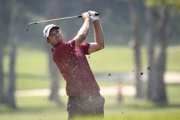 Justin Rose of England hits the ball on the 9th hole during the 2nd round of the Hong Kong Open golf tournament, Friday, Oct. 23, 2015. (AP Photo/Kin Cheung)