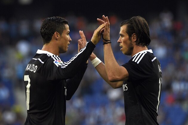 Real Madrid's Portuguese forward Cristiano Ronaldo (L) and Real Madrid's Welsh forward Gareth Bale (R) celebrate a goal during the Spanish league football match RCD Espanyol vs Real Madrid CF at the Cornella-El Prat stadium in Cornella de Llobregat on May 17, 2015.   AFP PHOTO / LLUIS GENE        (Photo credit should read LLUIS GENE/AFP/Getty Images)
