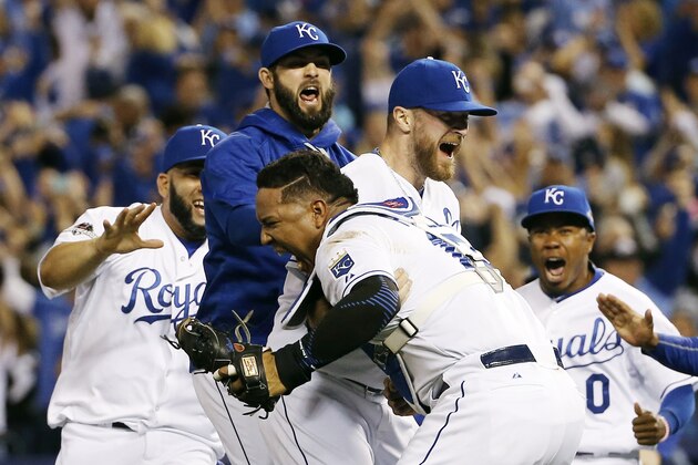 Kansas City Royals catcher Salvador Perez, and relief pitcher Wade Davis celebrate after their 4-3 win against the Toronto Blue Jays Game 6 of baseball's American League Championship Series on Friday, Oct. 23, 2015, in Kansas City, Mo. (AP Photo/Matt Slocum)