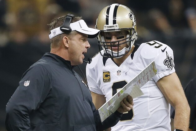 New Orleans Saints head coach Sean Payton speaks to New Orleans Saints quarterback Drew Brees (9) during the first half of an NFL football game against the Atlanta Falcons, Thursday, Oct. 15, 2015, in New Orleans. (AP Photo/Gerald Herbert)