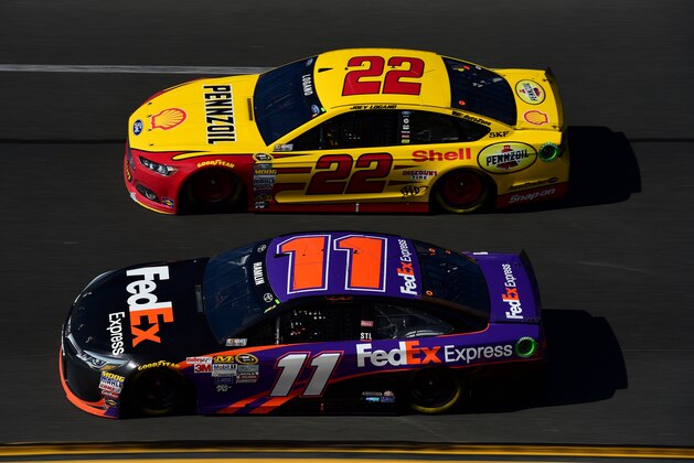 DAYTONA BEACH, FL - FEBRUARY 22:  Denny Hamlin, driver of the #11 FedEx Express Toyota, races Joey Logano, driver of the #22 Shell Pennzoil Ford, during the NASCAR Sprint Cup Series 57th Annual Daytona 500 at Daytona International Speedway on February 22, 2015 in Daytona Beach, Florida.  (Photo by Robert Laberge/Getty Images)