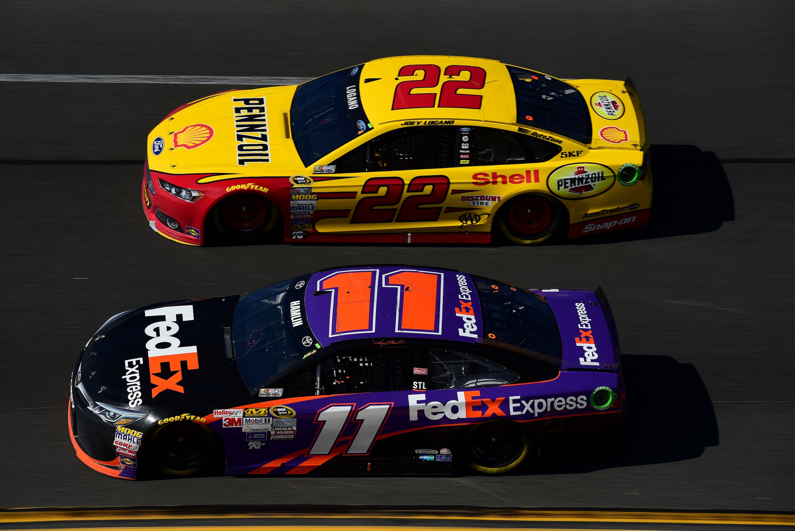 DAYTONA BEACH, FL - FEBRUARY 22:  Denny Hamlin, driver of the #11 FedEx Express Toyota, races Joey Logano, driver of the #22 Shell Pennzoil Ford, during the NASCAR Sprint Cup Series 57th Annual Daytona 500 at Daytona International Speedway on February 22, 2015 in Daytona Beach, Florida.  (Photo by Robert Laberge/Getty Images)