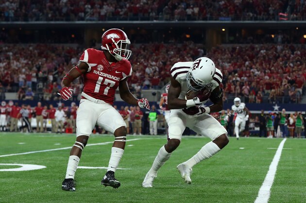 ARLINGTON, TX - SEPTEMBER 26:  Donovan Wilson #6 of the Texas A&M Aggies makes a pass interception in front of JoJo Robinson #17 of the Arkansas Razorbacks during the Southwest Classic at AT&T Stadium on September 26, 2015 in Arlington, Texas.  (Photo by Ronald Martinez/Getty Images)