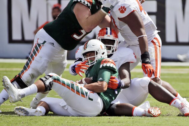 Clemson defensive end Shaq Lawson, lower right, sacks Miami quarterback Brad Kaaya during the first half of an NCAA College football game, Saturday, Oct. 24, 2015 in Miami Gardens, Fla. (AP Photo/Wilfredo Lee)