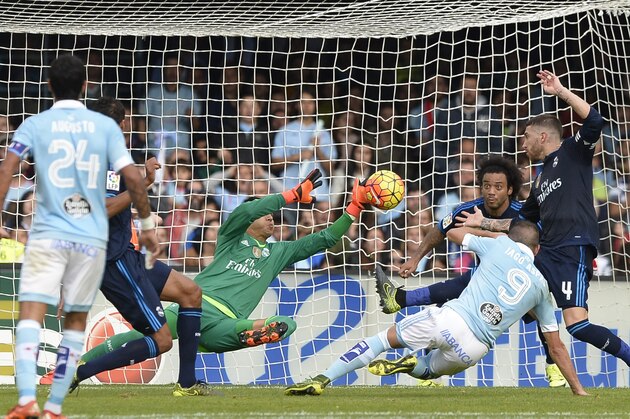 Real Madrid's Costa Rican goalkeeper Keylor Navas (C) stops a ball kicked by Celta Vigo's forward Iago Aspas (2R) during the Spanish league football match Celta Vigo vs Real Madrid CF at the Balaidos stadium in Vigo on October 24, 2015.  AFP PHOTO / MIGUEL RIOPA        (Photo credit should read MIGUEL RIOPA/AFP/Getty Images)