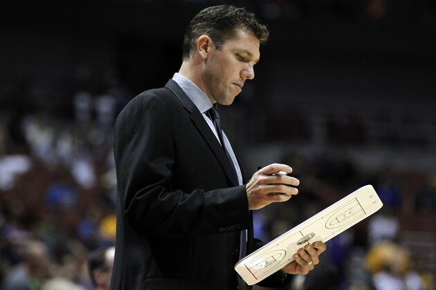 Golden State Warriors interim head coach Luke Walton looks over his notes during the first half of an NBA preseason basketball game against the Los Angeles Lakers in Anaheim, Calif., Thursday, Oct. 22, 2015. (AP Photo/Alex Gallardo)