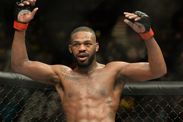 Jan 3, 2015; Las Vegas, NV, USA; Jon Jones (red gloves) celebrates after defeating Daniel Cormier (not pictured) in their light heavyweight title fight at UFC 182 at the MGM Grand Garden Arena. Jones won. Mandatory Credit: Jayne Kamin-Oncea-USA TODAY Sports
