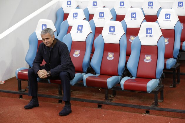 Chelsea's head coach Jose Mourinho waits for the match to start after taking his seat pitch side, prior to the start of the English Premier League soccer match between West Ham and Chelsea at Upton Park stadium in London, Saturday, Oct. 24, 2015.  (AP Photo/Matt Dunham)
