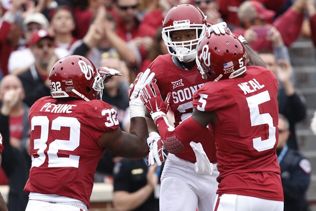 Oklahoma running back Joe Mixon (25) celebrates a touchdown with teammates Samaje Perine (32) and wide receiver Durron Neal (5) in the first quarter of an NCAA college football game against Texas Tech in Norman, Okla., Saturday, Oct. 24, 2015. (AP Photo/Sue Ogrocki)