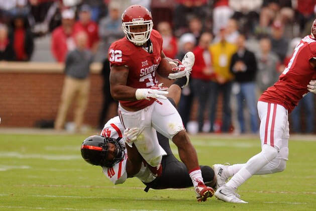 Oct 24, 2015; Norman, OK, USA; Oklahoma Sooners running back Samaje Perine (32) runs through a tackle attempt by Texas Tech Red Raiders linebacker Dakota Allen (40) during the second quarter at Gaylord Family - Oklahoma Memorial Stadium. Mandatory Credit: Mark D. Smith-USA TODAY Sports