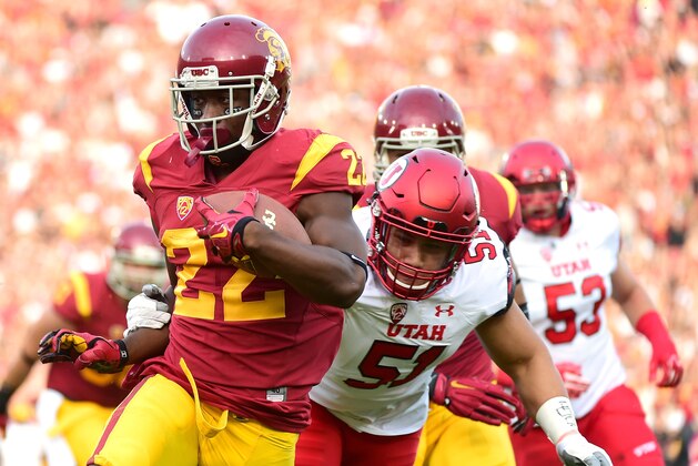 LOS ANGELES, CA - OCTOBER 24:  Justin Davis #22 of the USC Trojans scores a touchdown past Jason Fanaika #51 of the Utah Utes to take a 7-0 lead during the first quarter at Los Angeles Memorial Coliseum on October 24, 2015 in Los Angeles, California.  (Photo by Harry How/Getty Images)