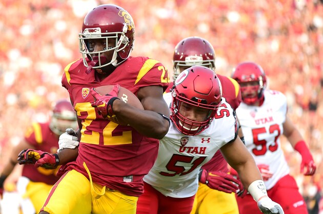 LOS ANGELES, CA - OCTOBER 24:  Justin Davis #22 of the USC Trojans scores a touchdown past Jason Fanaika #51 of the Utah Utes to take a 7-0 lead during the first quarter at Los Angeles Memorial Coliseum on October 24, 2015 in Los Angeles, California.  (Photo by Harry How/Getty Images)