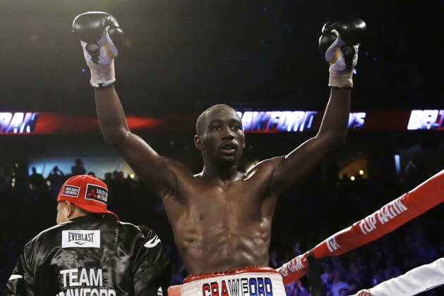 FILE - This Nov. 30, 2014, file photo shows Terence Crawford celebrating after defeating Raymundo Beltran to retain his WBO lightweight title in a boxing match in Omaha, Neb. Lightweight Terence