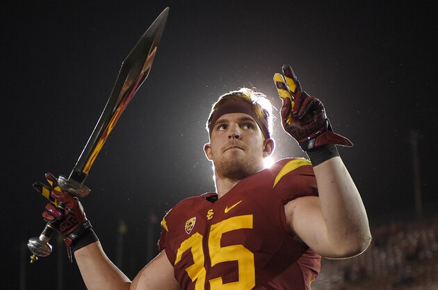 Southern California linebacker Cameron Smith directs the USC Marching Band after Southern California defeated Utah 42-24 in an NCAA college football game, Saturday, Oct. 24, 2015, in Los Angeles. (AP Photo/Mark J. Terrill)
