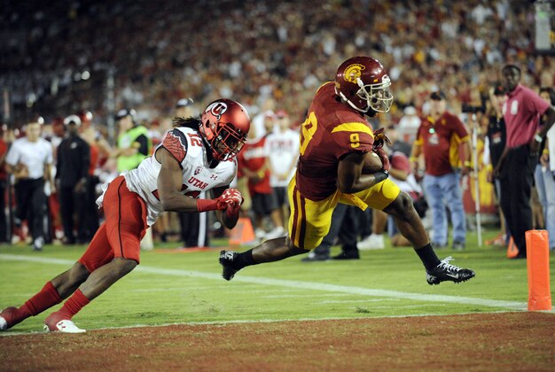 October 24, 2015; Los Angeles, CA, USA; Southern California Trojans wide receiver JuJu Smith-Schuster (9) moves in to score a touchdown ahead of Utah Utes defensive back Justin Thomas (12) during the second half at Los Angeles Memorial Coliseum. Mandatory Credit: Gary A. Vasquez-USA TODAY Sports