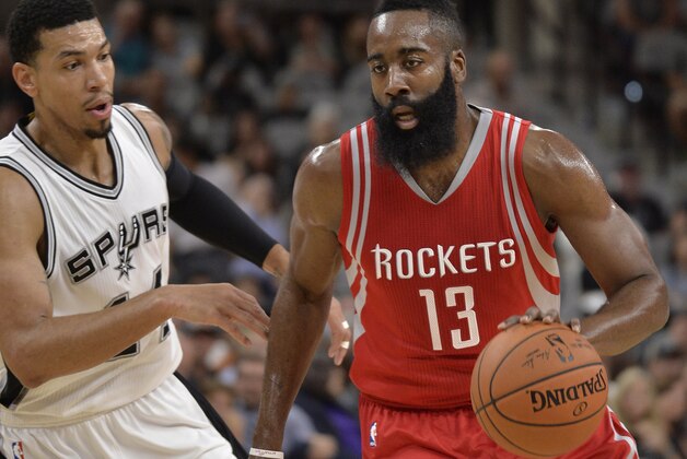 Houston Rockets guard James Harden (13) drives around San Antonio Spurs guard Danny Green during the first half of a preseason NBA basketball game, Friday, Oct. 23, 2015, in San Antonio. (AP Photo/Darren Abate)
