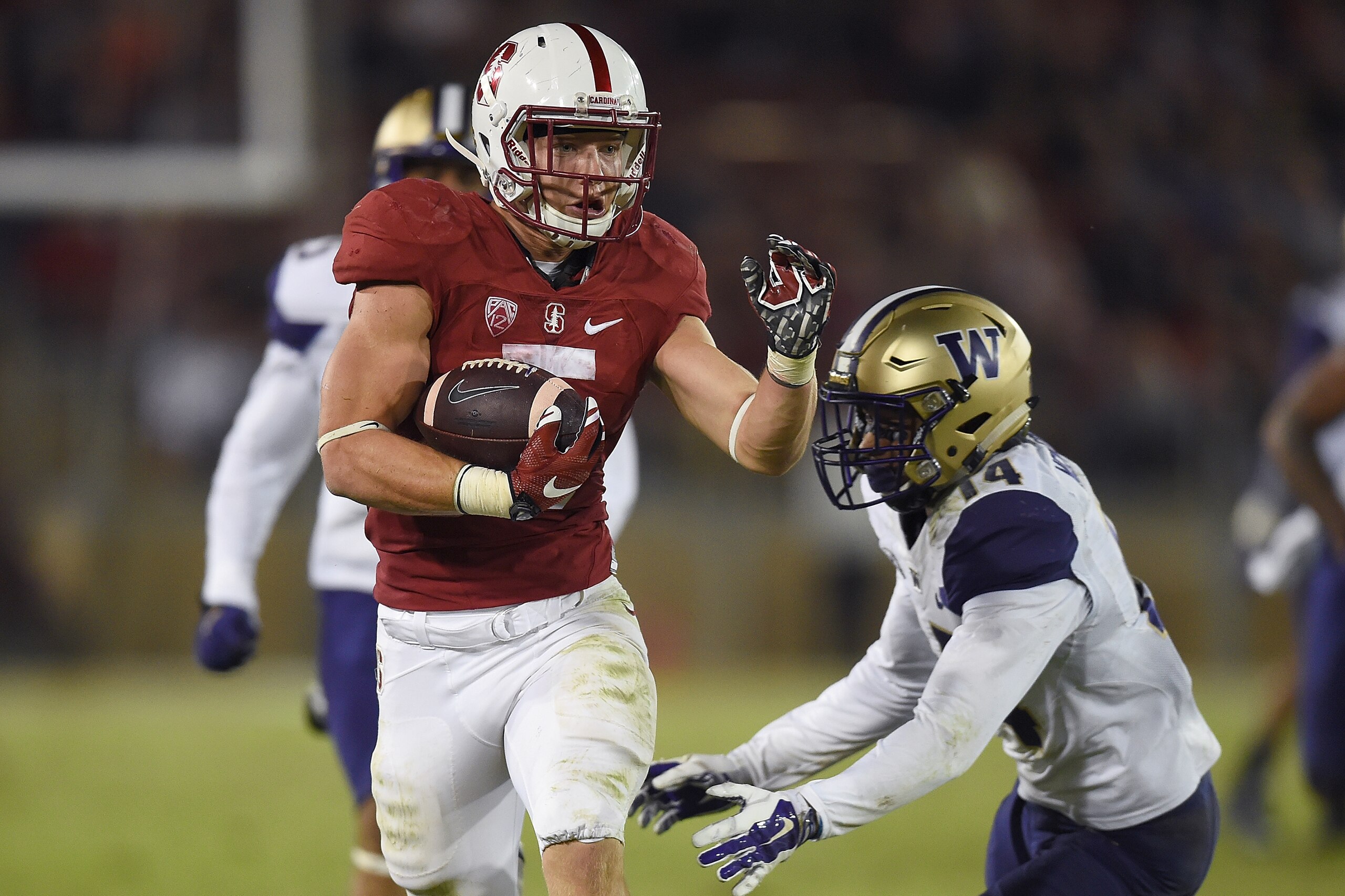 STANFORD, CA - OCTOBER 24:  Christian McCaffrey #5 of the Stanford Cardinal's scores a touchdown breaking the tackle of  JoJo McIntosh #14 of the Washington Huskies in the third quarter of an NCAA football game at Stanford Stadium on October 24, 2015 in Stanford, California.  (Photo by Thearon W. Henderson/Getty Images)