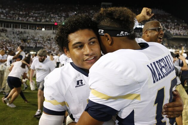 Georgia Tech quarterback Justin Thomas, left, embraces Georgia Tech running back TaQuon Marshall after the second half of an NCAA college football game against Florida State, Saturday, Oct. 24, 2015, in Atlanta. Georgia Tech won 22-16. (AP Photo/Mike Stewart)