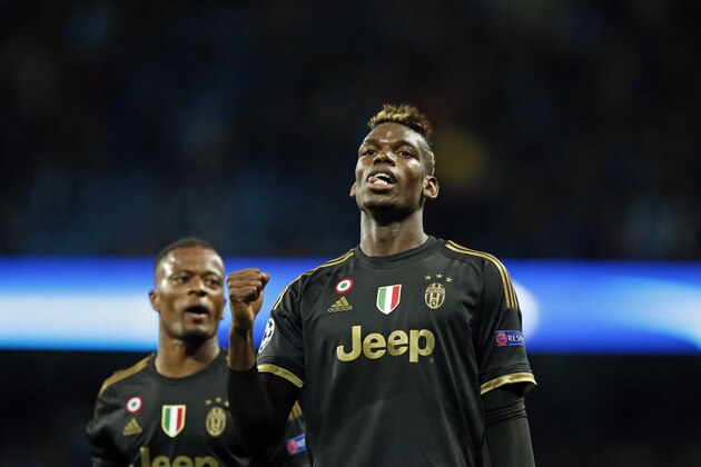 Juventus' Paul Pogba, right, and Patrice Evra celebrate after the Champions League group D soccer match between Manchester City and Juventus at the Etihad Stadium, Manchester, England, Tuesday, Sept. 15, 2015. Juventus won the match 2-1. (AP Photo/Jon Super)
