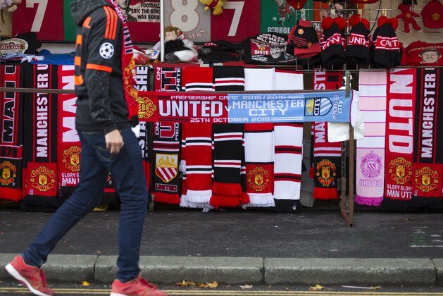 Merchandise is seen for sale before the English Premier League soccer match between Manchester United and Manchester City at Old Trafford Stadium, Manchester, England, Sunday, Oct. 25, 2015. (AP Photo/Jon Super)