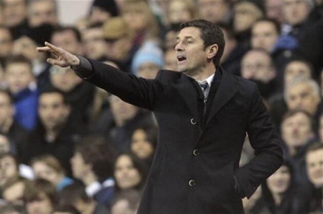 Lyon's coach Remi Garde reacts as he watches his team play against Tottenham Hotspur during their Europa League round of 32 first leg soccer match at White Hart Lane, London, Thursday, Feb. 14, 2013. (AP Photo/Sang Tan)