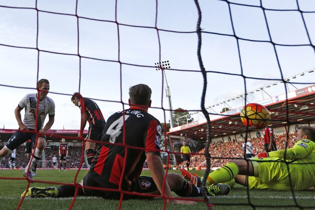 Tottenham Hotspur's English striker Harry Kane (L) scores his third goal during the English Premier League football match between Bournemouth and Tottenham Hotspur at the Vitality Stadium in Bournemouth, southern England on October 25, 2015. Tottenham won the game 5-1. AFP PHOTO / IAN KINGTON

RESTRICTED TO EDITORIAL USE. No use with unauthorized audio, video, data, fixture lists, club/league logos or 'live' services. Online in-match use limited to 75 images, no video emulation. No use in betting, games or single club/league/player publications.        (Photo credit should read IAN KINGTON/AFP/Getty Images)