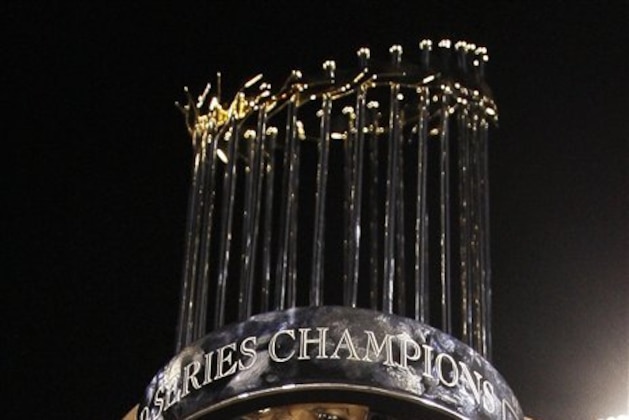 Philadelphia Phillies' Ryan Howard is reflected in the World Series trophy after Game 5 of the baseball World Series in Philadelphia, Wednesday, Oct. 29, 2008. The Phillies defeated the Tampa Bay Rays 4-3 to win the series. (AP Photo/David J. Phillip)