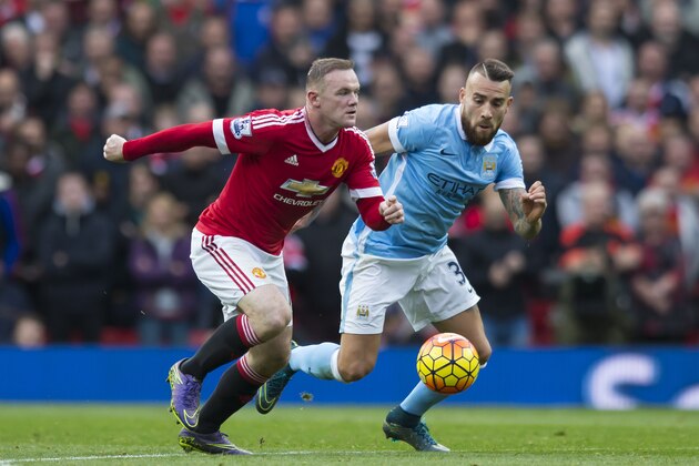 Manchester United's Wayne Rooney fights for the ball against Nicolas Otamendi of Manchester City during the English Premier League soccer match between Manchester United and Manchester City at Old Trafford Stadium, Manchester, England, Sunday, Oct. 25, 2015. (AP Photo/Jon Super)