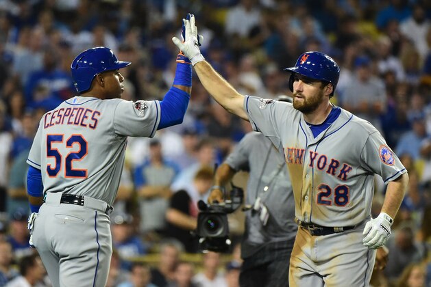 LOS ANGELES, CA - OCTOBER 15:  Daniel Murphy #28 of the New York Mets celebrates with Yoenis Cespedes #52 after Murphy hits a solo home run in the sixth inning against the Los Angeles Dodgers in game five of the National League Division Series at Dodger Stadium on October 15, 2015 in Los Angeles, California.  (Photo by Harry How/Getty Images)