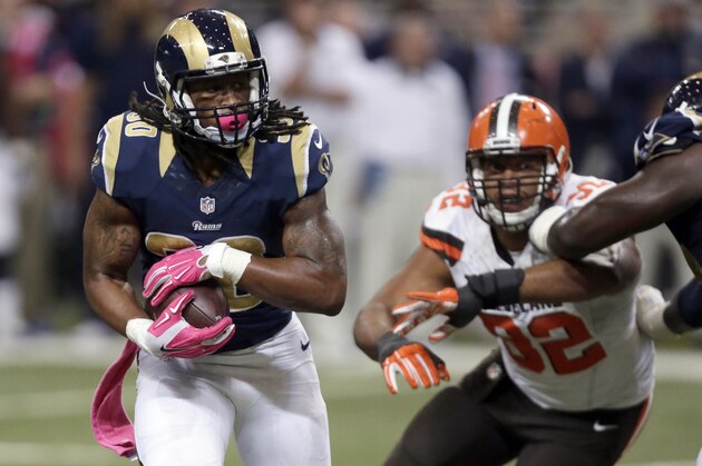 St. Louis Rams running back Todd Gurley, left, runs past Cleveland Browns defensive end Desmond Bryant on his way to a 16-yard touchdown run during the fourth quarter of an NFL football game Sunday, Oct. 25, 2015, in St. Louis. (AP Photo/Tom Gannam)