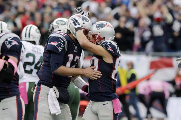 New England Patriots quarterback Tom Brad, left, celebrates his touchdown pass to wide receiver Danny Amendola (80) during the second half of an NFL football game against the New York Jets, Sunday, Oct. 25, 2015, in Foxborough, Mass. (AP Photo/Charles Krupa)