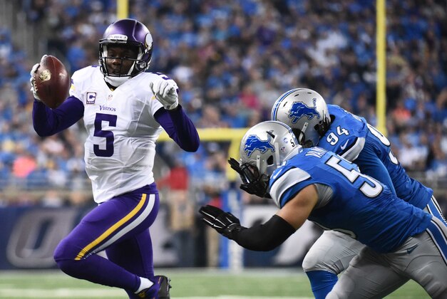 Oct 25, 2015; Detroit, MI, USA; Minnesota Vikings quarterback Teddy Bridgewater (5) is pressured by Detroit Lions defensive end Ezekiel Ansah (94) and outside linebacker Kyle Van Noy (53) during the first quarter at Ford Field. Mandatory Credit: Tim Fuller-USA TODAY Sports