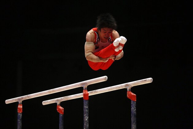 Japan's Kohei Uchimura performs on the parallel bars as he takes part in the men's qualification competition at the World Artistic Gymnastics championships in Glasgow, Scotland, Sunday, Oct. 25, 2015. (AP Photo/Matthias Schrader)