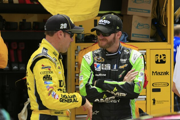 Matt Kenseth, left, talks with Dale Earnhardt Jr. before the NASCAR Sprint Cup series auto race at Michigan International Speedway, Sunday, June 14, 2015, in Brooklyn, Mich. (AP Photo/Carlos Osorio)