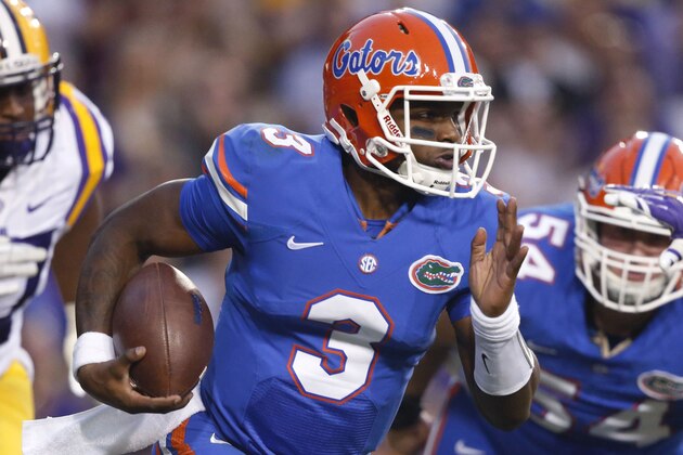 Florida quarterback Treon Harris (3) carries ahead of LSU defensive tackle Davon Godchaux (57) in the first half of an NCAA college football game in Baton Rouge, La., Saturday, Oct. 17, 2015. (AP Photo/Gerald Herbert)