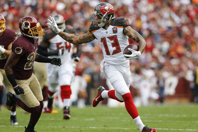Tampa Bay Buccaneers wide receiver Mike Evans (13) runs away from Washington Redskins cornerback Bashaud Breeland (26) during the first half of an NFL football game  in Landover, Md., Sunday, Oct. 25, 2015. (AP Photo/Patrick Semansky)